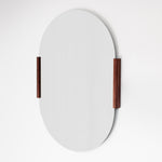 Round mirror with wooden frame on a white background