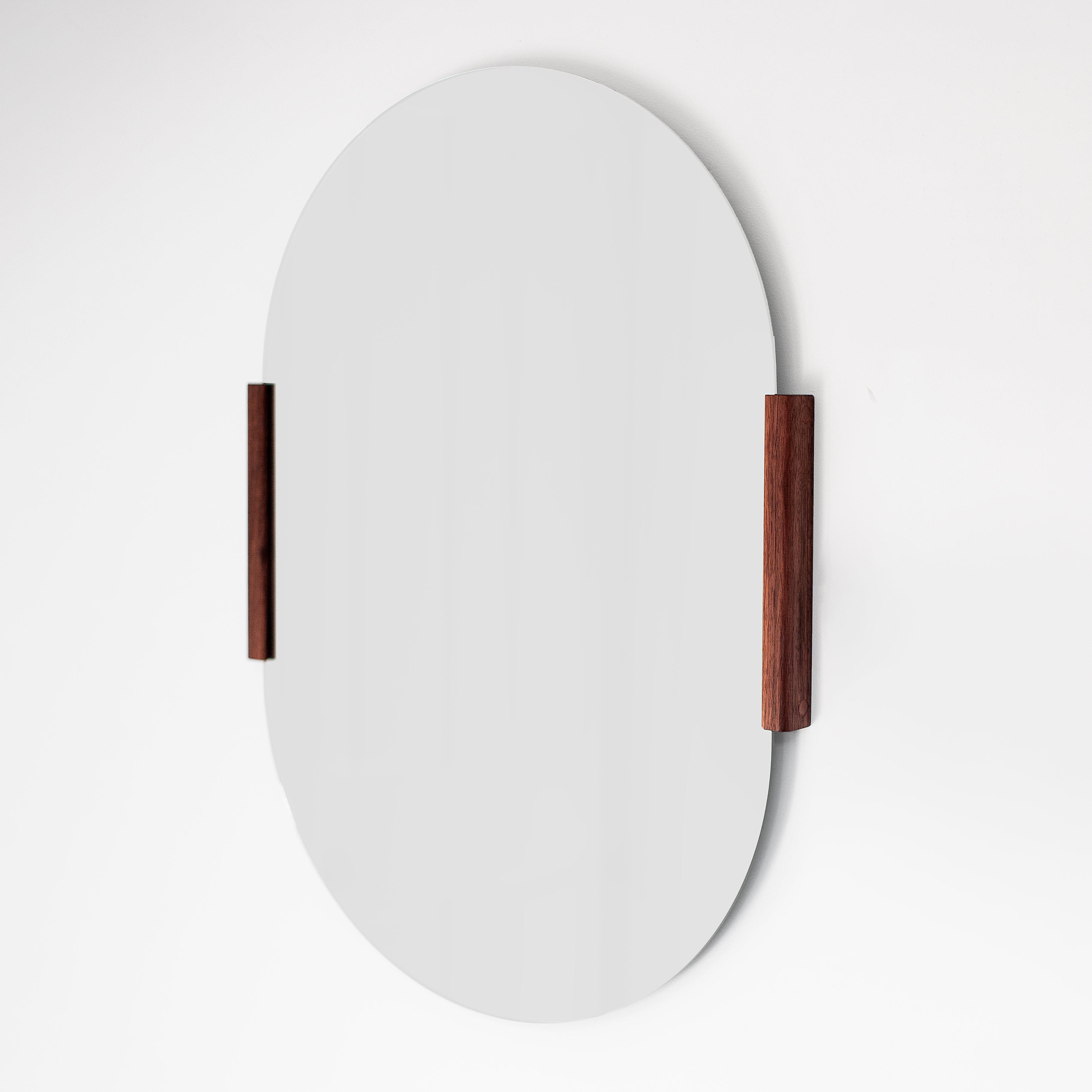 Round mirror with wooden frame on a white background