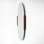 Round mirror with wooden frame on a white background