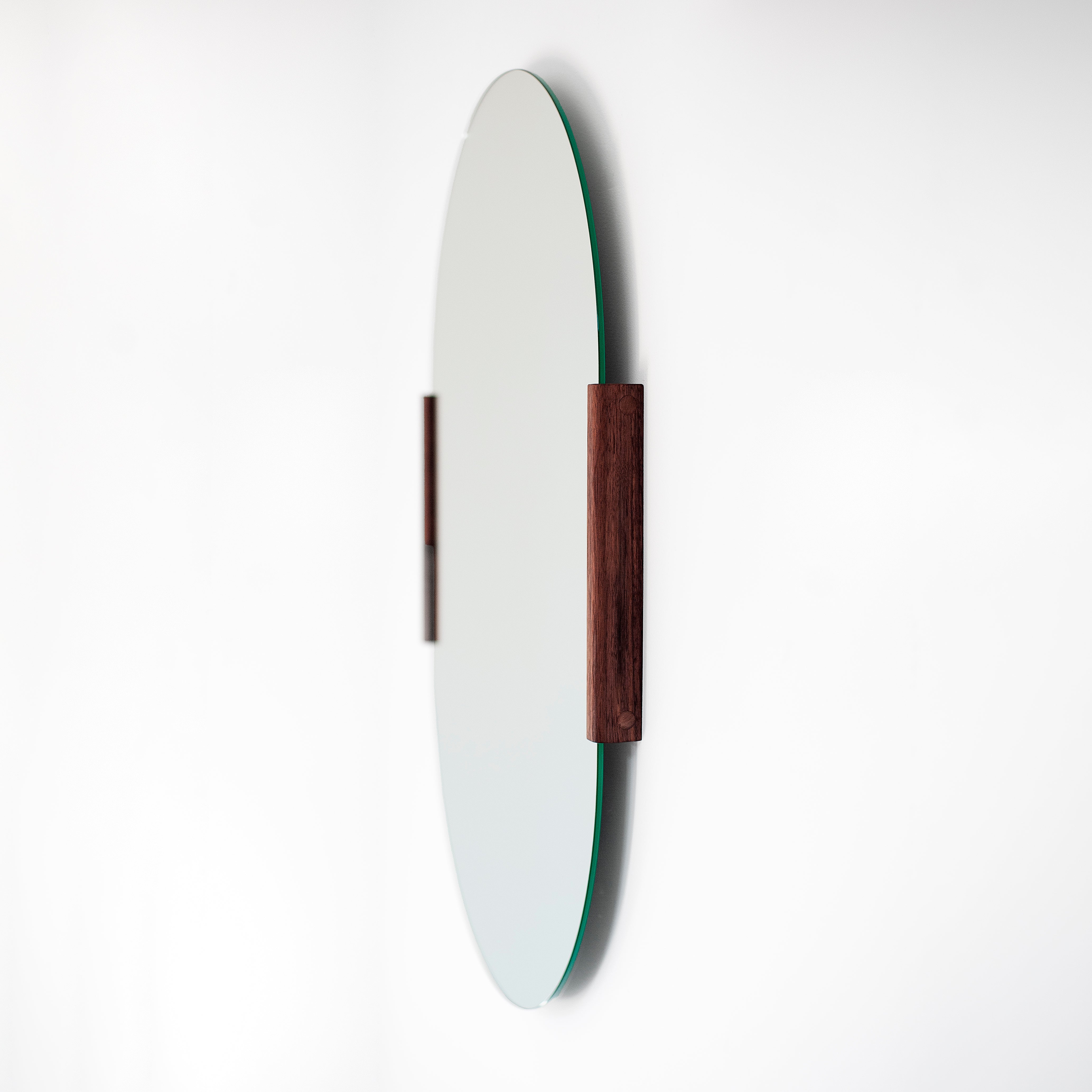 Round mirror with wooden frame on a white background
