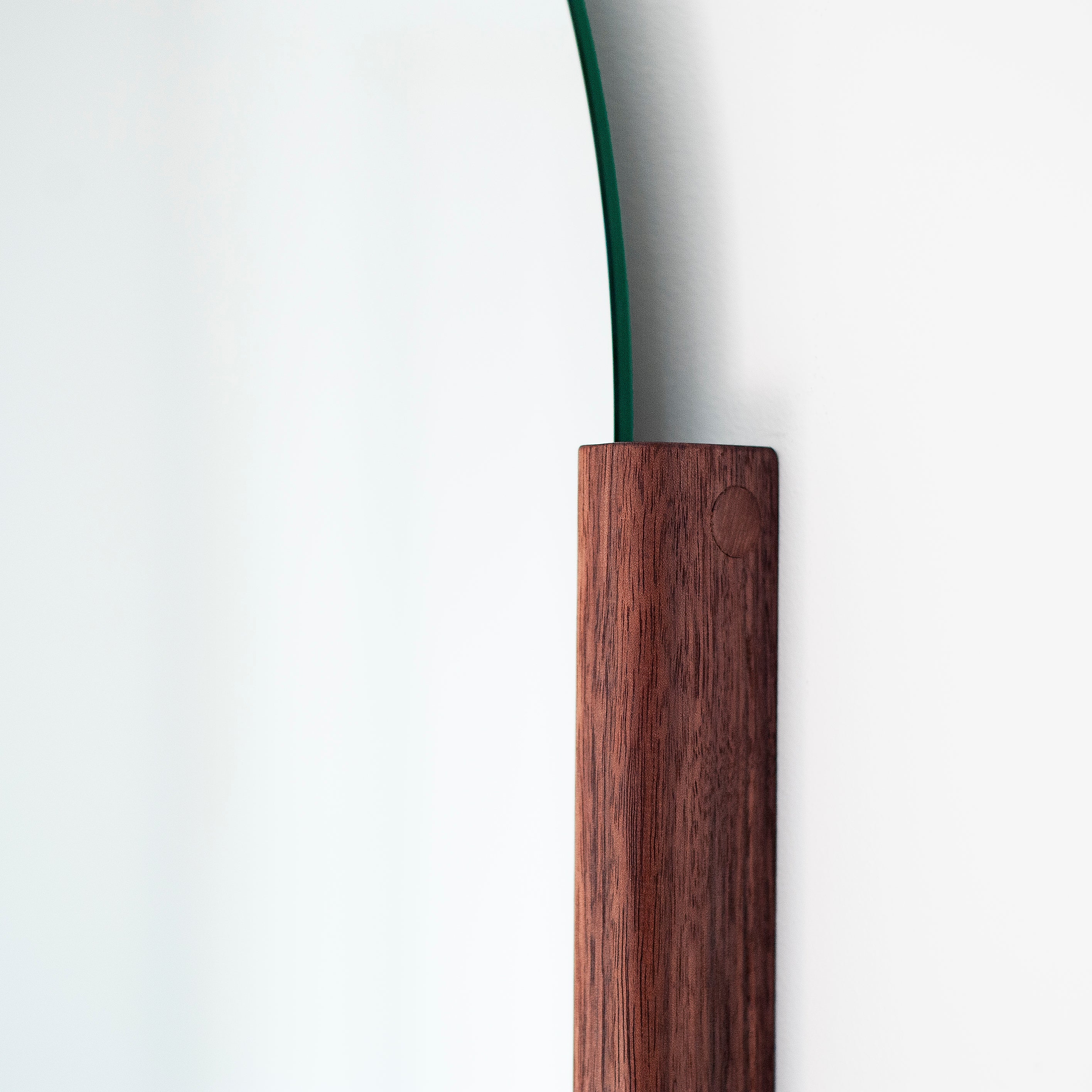 Round mirror with wooden frame on a white background