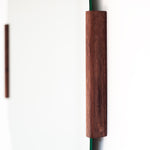 Round mirror with wooden frame on a white background