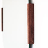 Round mirror with wooden frame on a white background