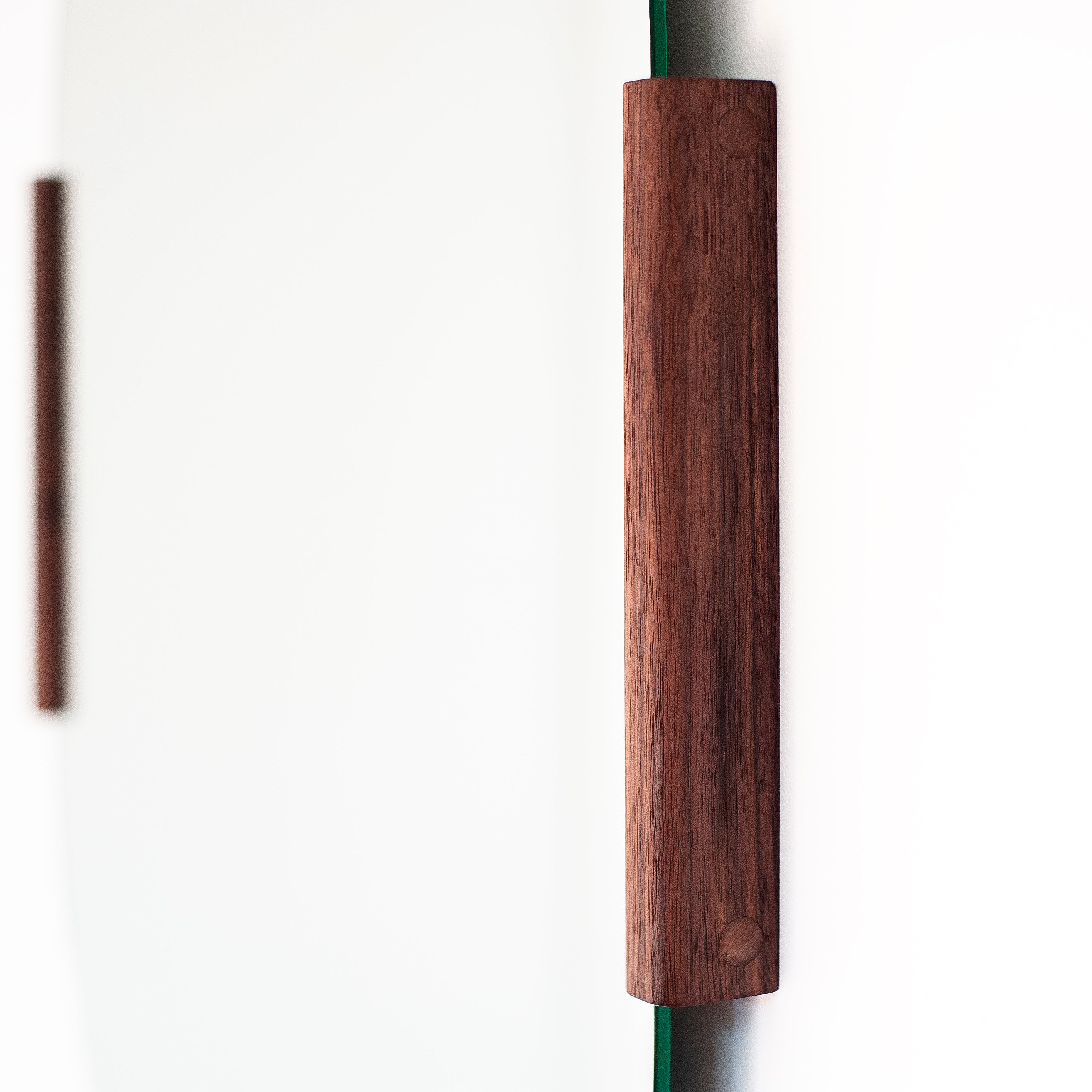 Round mirror with wooden frame on a white background