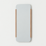 Rectangular mirror with wooden frame on a light beige background