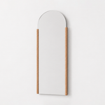 Arched wall mirror with a wooden frame on a white background