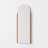 Arched wall mirror with a wooden frame on a white background