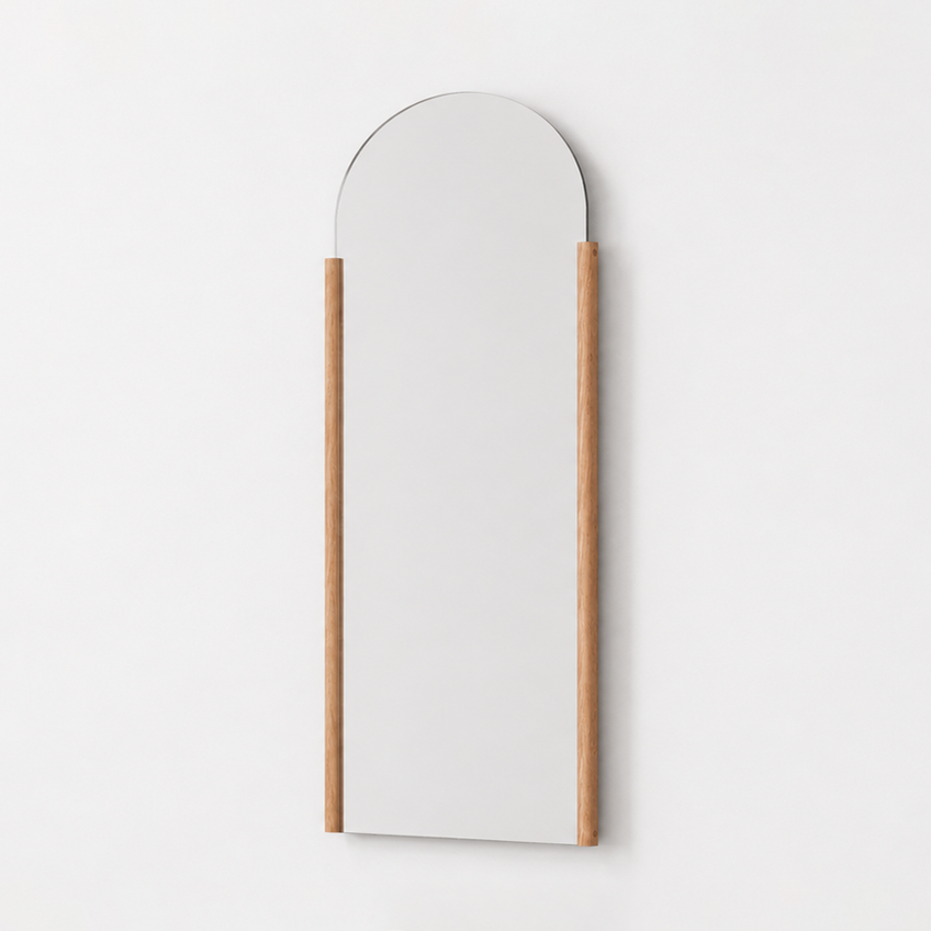 Arched wall mirror with a wooden frame on a white background