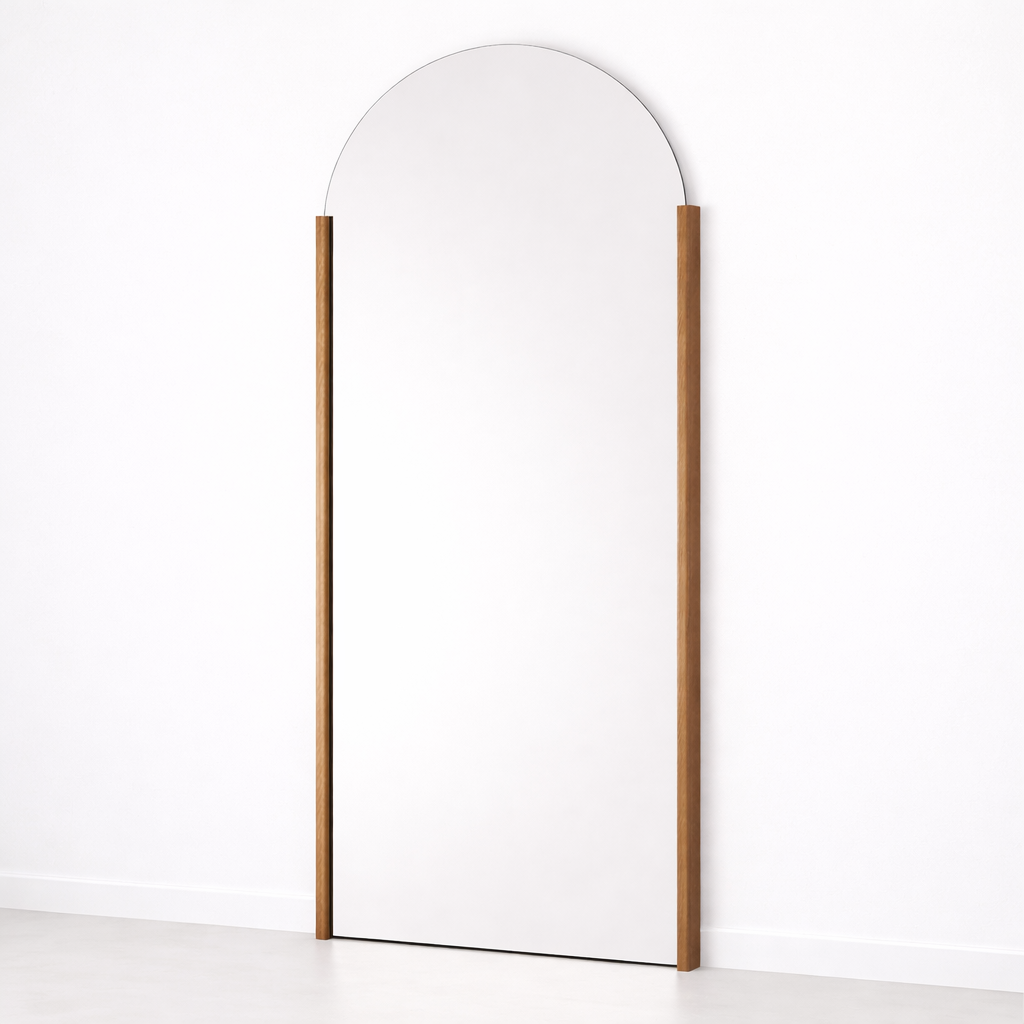 Tall, thin mirror with a wooden frame on a white background
