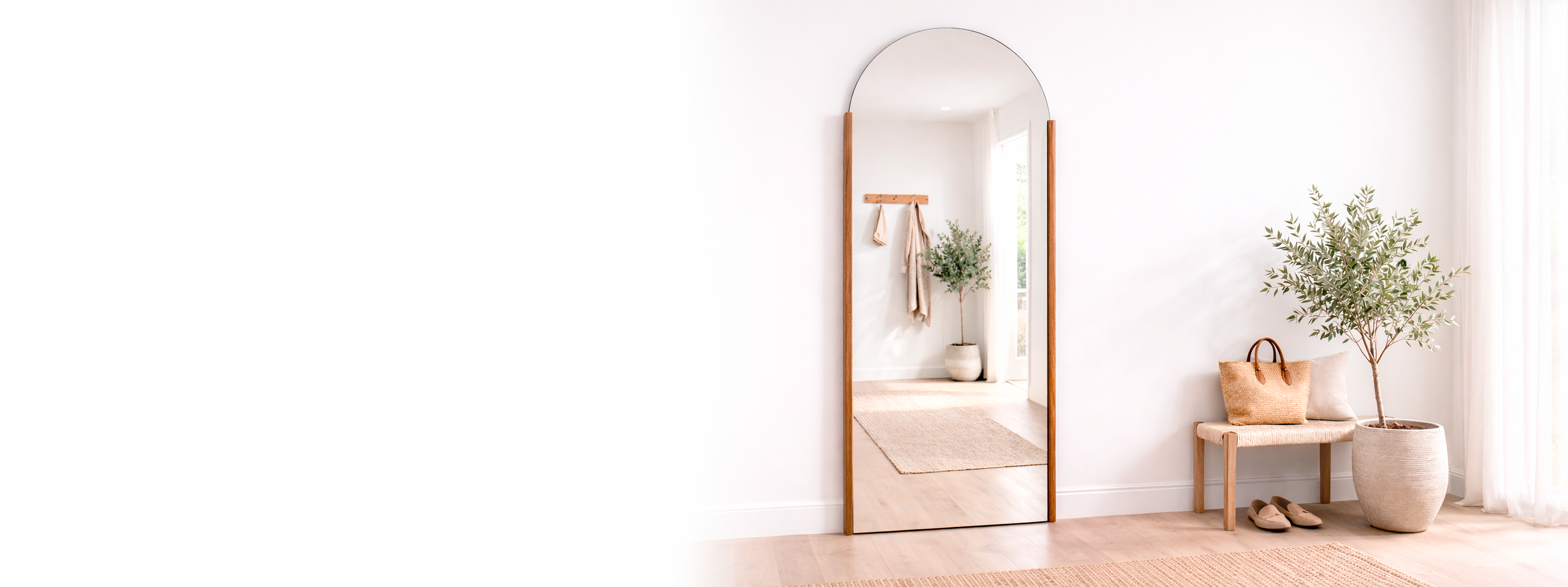 Long mirror leaning against a white wall with minimal decor.